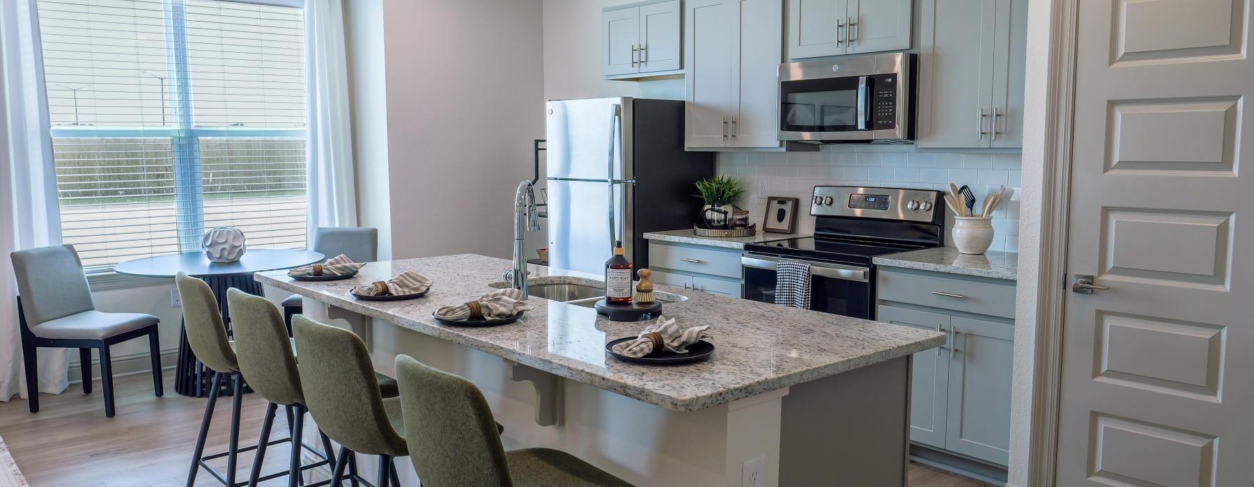 a kitchen with a marble island