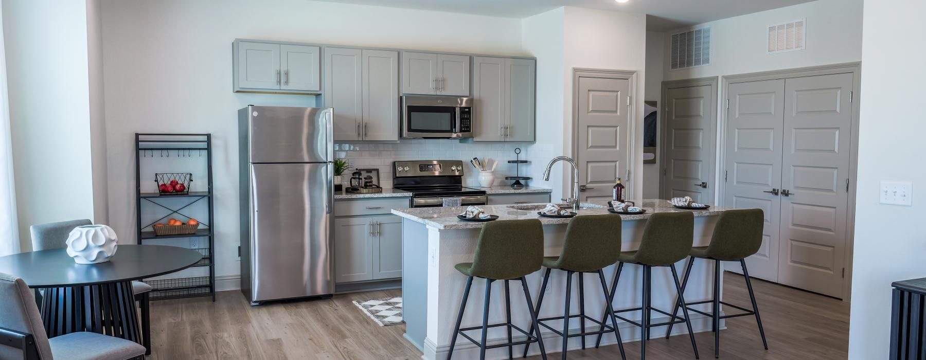 a kitchen with bar stools and an island