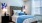 a bed with white sheets and a large window