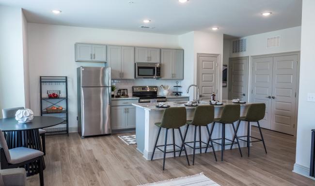 a kitchen with bar stools and an island